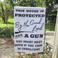 This House is Protected By The Good Lord and a Gun 18"x12" Garden Flag